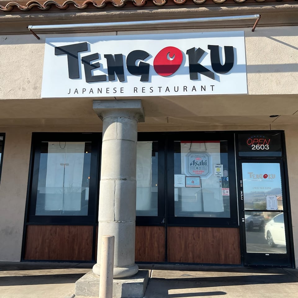 The exterior of Tengoku Japanese Restaurant, featuring its sign, entrance, and a decorative column.